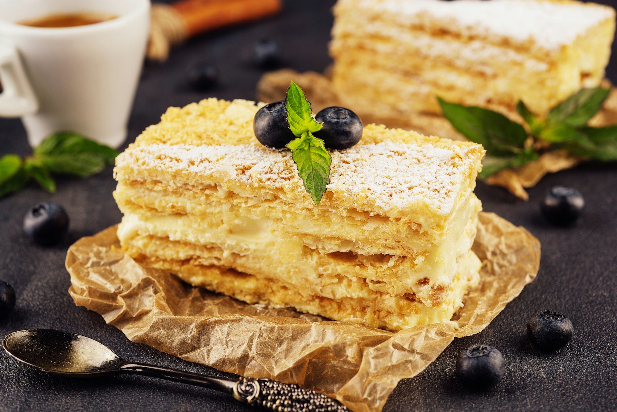 baked cake Napoleon, Millefeuille garnished with blueberry and mint