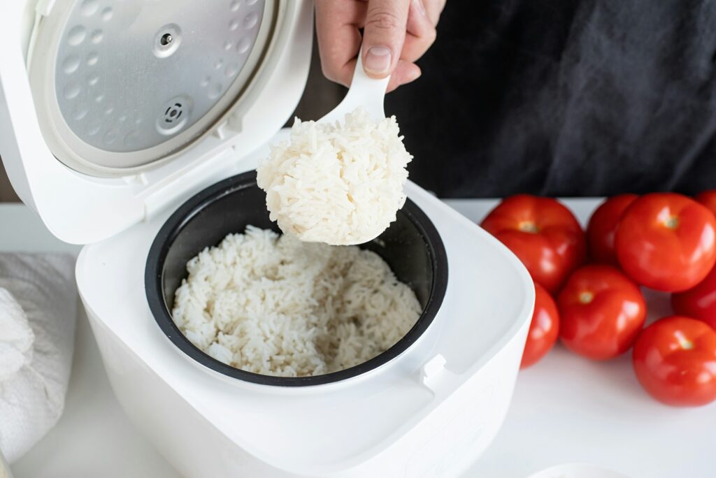 Electric rice cooker on wooden counter-top in the kitchen