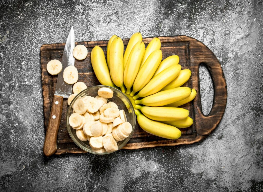 Fresh bananas with pieces of sliced bananas in a bowl.
