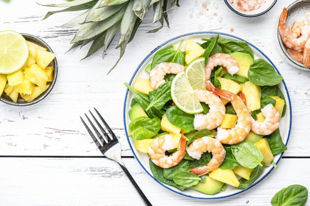 Fresh pineapple shrimp salad with spinach, avocado and lime
