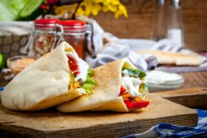 Fried chicken meat with vegetables in pita bread