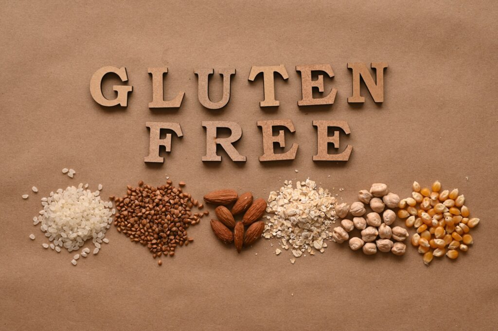 Gluten free text and gluten free products on brown background