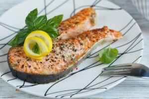 Grilled Salmon steak with lemon and herbs.