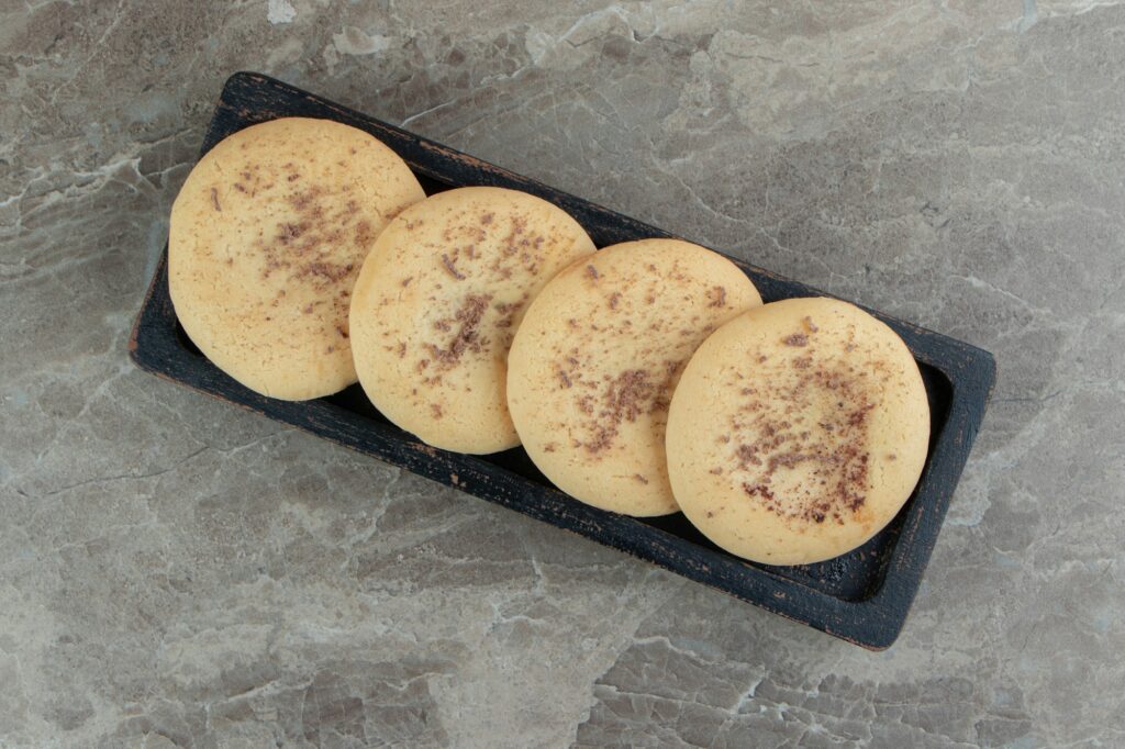 Homemade cookies stuffed with chocolate on black plate
