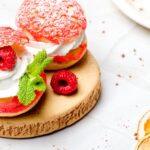 Shu cake. Custard dessert with creamy white cream, decorated with raspberries